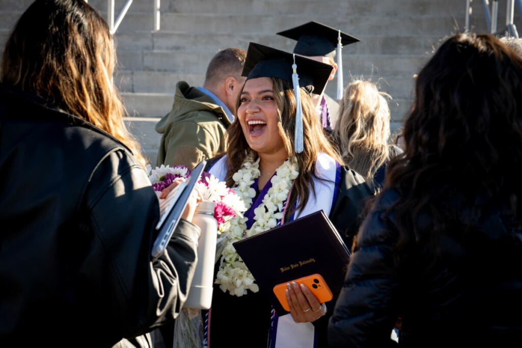 USHE graduate smiling