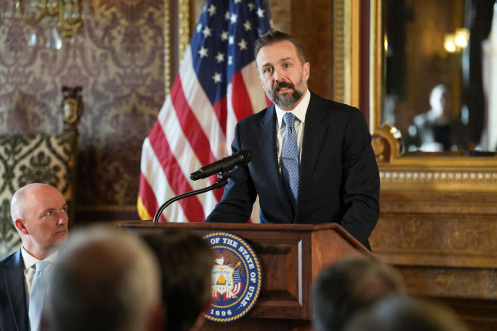 USHE Commissioner Geoffrey Lanward speaking at the signing event
