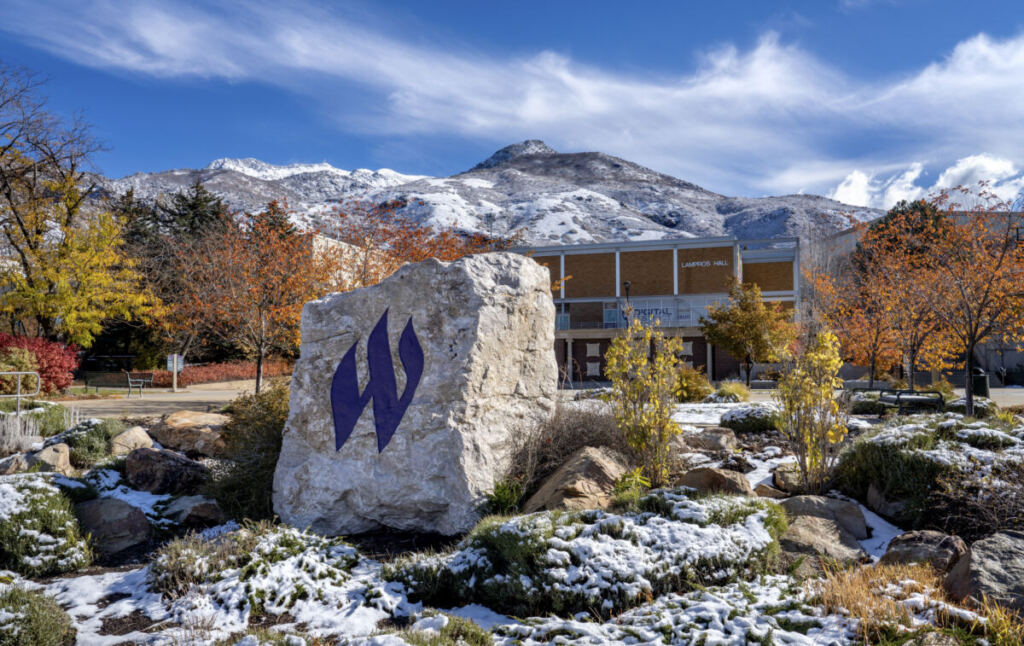 Rock with Weber State logo on it surrounded by snow