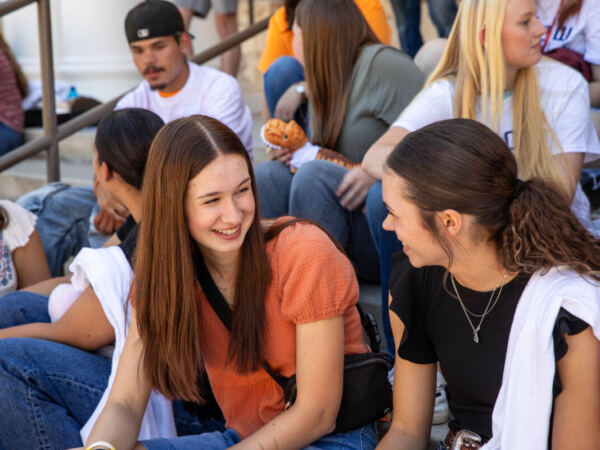 Students chatting on bleachers